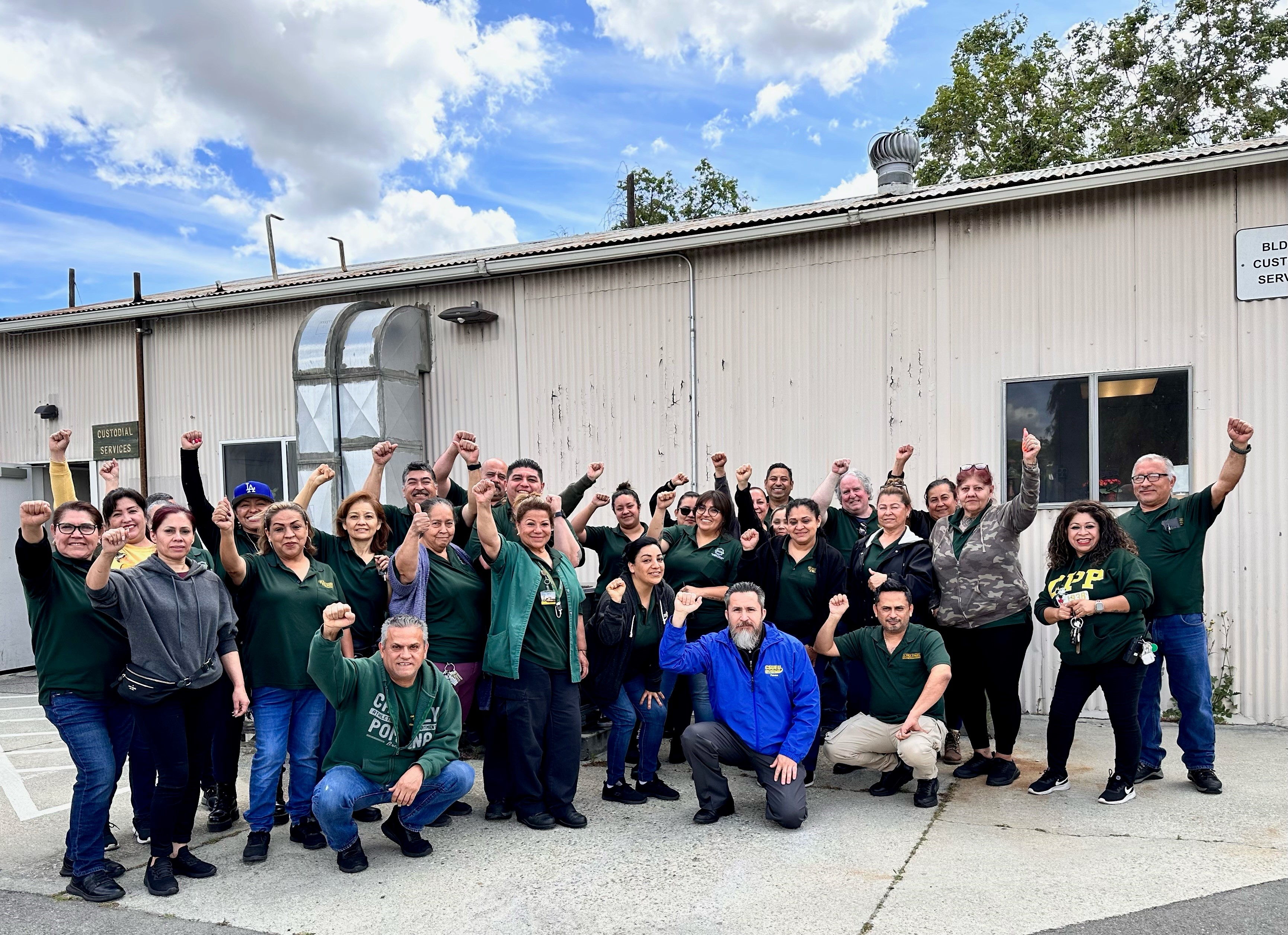 Cal Poly Pomona Custodians in Photograph showing victory sign